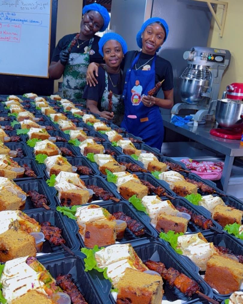 Het team van SPF Catering achter rijen kant-en-klare cateringbakjes